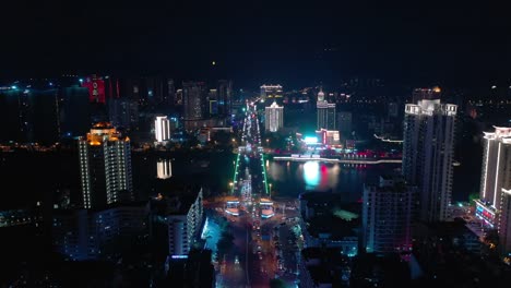 night-illumination-hainan-island-sanya-city-traffic-street-river-bridge-aerial-topdown-view-4k-china