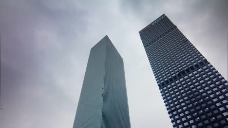 china-guangzhou-two-skyscrapers-sky-up-view-4k-time-lapse