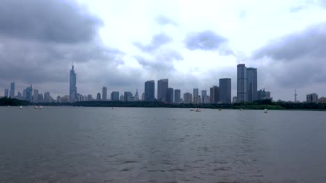 Modern-city-skyscrapers-of-Nanjing-with-rippling-water-of-Xuanwu-Lake