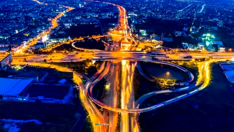 Timelapse-aerial-view-of-cityscape-and-traffic-on-highway-at-night.-4K