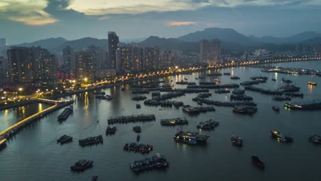 noche-puesta-de-sol-de-China-zhuhai-iluminada-ciudad-Bahía-Puerto-famoso-muelle-panorama-aéreo-4k-lapso-de-tiempo