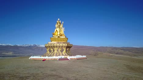 Big-Buddha-on-the-grass-hill-at-Yarchen-Gar-Monastery-in-Garze-Tibetan,-Sichuan,-China.