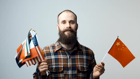 Man-holding-national-flags