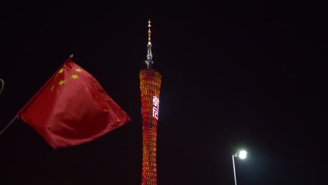 night-illuminated-guangzhou-city-famous-canton-tower-and-national-flag-panorama-4k-china