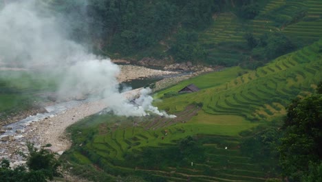 vietnamese-farmer-burning-stubble-in-rice-paddy-field-terraces-in-Sa-Pa,-Vietnam,-Asia