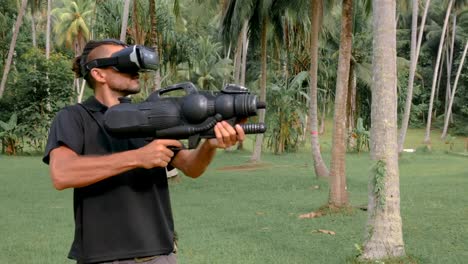 Man-with-weapon-playing-virtual-reality-game-in-the-jungle