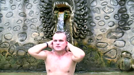 A-man-stands-in-the-swimming-pool-with-mineral-water