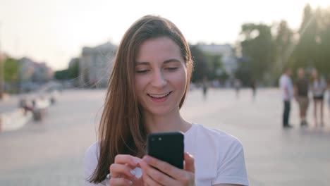 Young-Lady-Using-Phone-in-Town