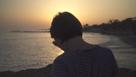 Casual-woman-dancing-in-headphones-on-shore