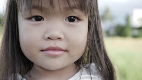 Slow-motion,-Close-up-adorable-little-girl-smiling-and-shy