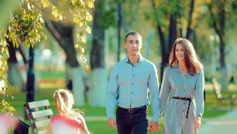 Young-happy-couple-walking-in-beautiful-summer-park