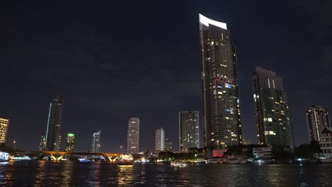 corporate-buildings-of-the-metropolis-at-night-on-the-river-bank.-business-center-of-a-lively-city