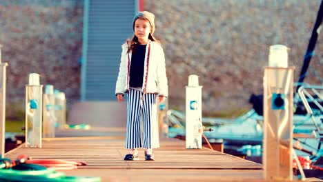 Small-child-strolls-along-the-marina-and-boats