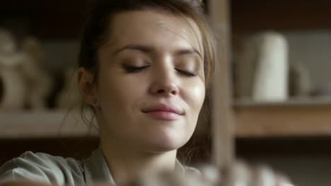 Female-Artisan-Wetting-Hands-and-Working-with-Pottery