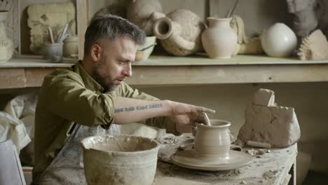 Artisan-Wetting-Hands-and-Throwing-Vase