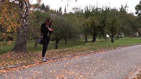 Young-brunette-girl-is-waiting-for-a-guy-with-flowers-on-a-date