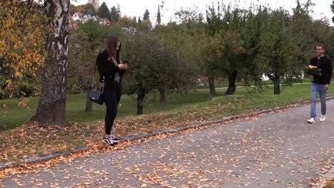 Young-brunette-girl-is-waiting-for-a-guy-with-flowers-on-a-date