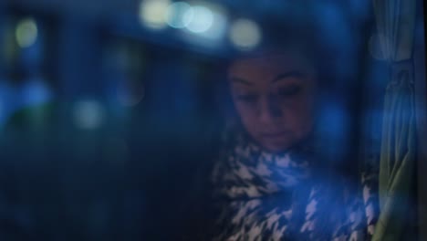 Reflection-of-woman-by-the-window-traveling-by-bus