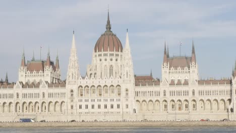 Hungarian-parliament-building-located-on-river-Danube--and-city-of-Budapest-by-the-day-4K