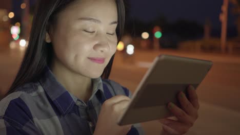 Happy-woman-communicating-with-digital-tablet-in-modern-city