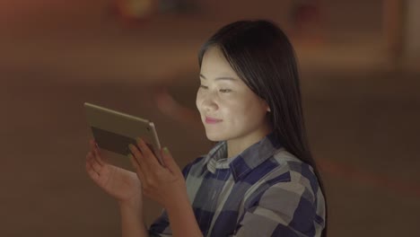 Happy-woman-communicating-with-digital-tablet-in-modern-city