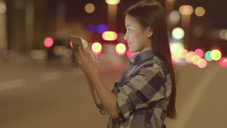 Happy-woman-communicating-with-digital-tablet-in-modern-city