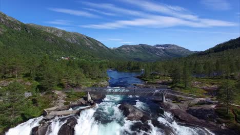 Young-girl-watching-waterfall-in-Norway