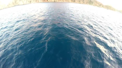 Wide-angle-of-ocean-water-flowing-under-a-boat