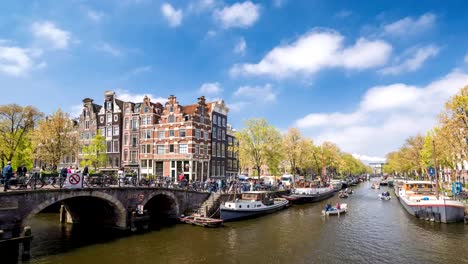 Amsterdam-city-skyline-timelapse-at-canal-waterfront,-Amsterdam,-Netherlands,-4K-Time-Lapse