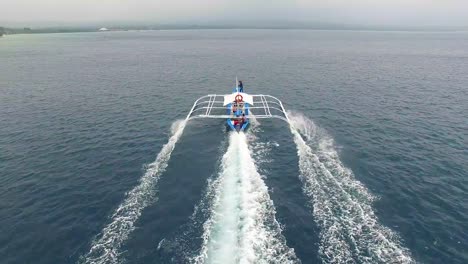Drone-Shot-of-Filipino-Boat-Moving-In-The-Beautiful-Tropical-Sea.