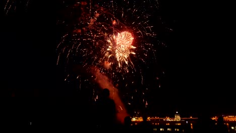 A-crowd-of-people-watch-colorful-fireworks-and-celebrate.