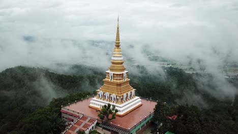 Aerial-view,-Wat-Mon-Pra-Jao-Lai-with-fog-on-the-mountain-in-Chiang-Rai,-Thailand.