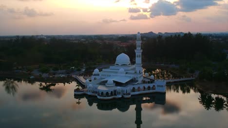 Aerial-4k-footage-of-floating-mosque-during-sunset-in-a-tropical-country.