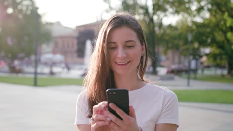 Young-Lady-Using-Phone-in-Town