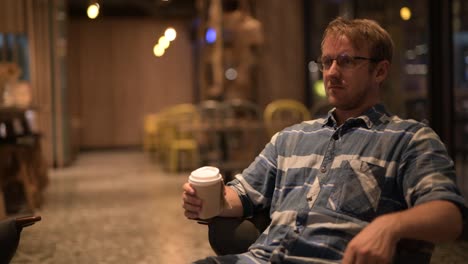 Handsome-businessman-thinking-while-drinking-coffee