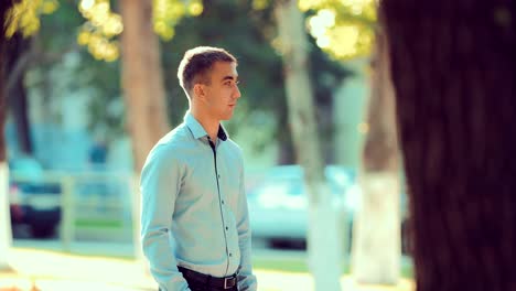 Portrait-of-a-young-man-waiting-for-a-woman-on-a-date-in-the-summer-or-in-the-spring-season-in-the-park