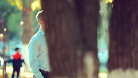 Handsome-young-man-waiting-for-a-girl-on-a-date-in-the-park