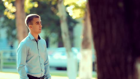 Handsome-young-man-waiting-for-a-girl-on-a-date-in-the-park