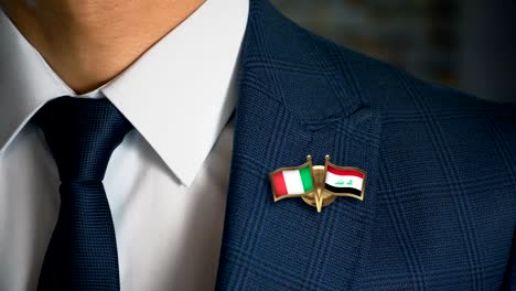 Geschäftsmann-zu-Fuß-in-Richtung-Kamera-mit-Freund-Flaggen-Pin-Italien---Irak