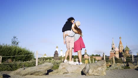 Young-couple-standing-against-beautiful-cityscape