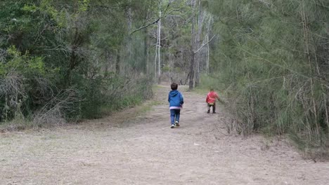 Two-Boys-Running-in-Forest