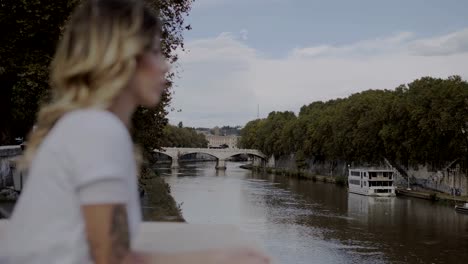blurred-sad-beautiful-woman-looking-the-river-in-Rome,Italy