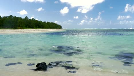 Forested-coastline-and-blue-lagoon,-Mauritius