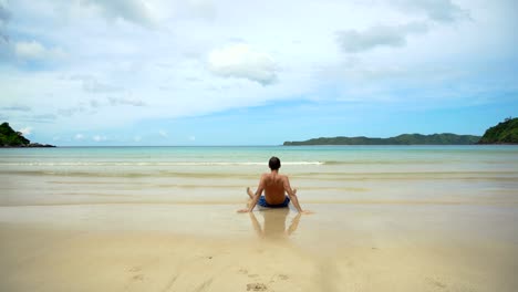 Man-sitting-on-the-beach