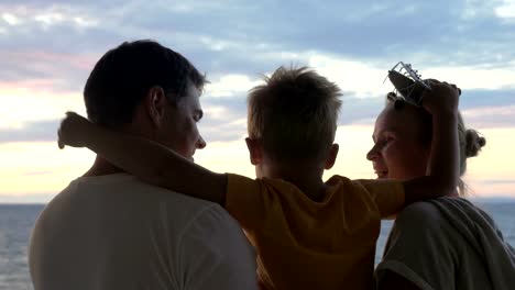 Child-with-toy-plane-and-parents-outdoor