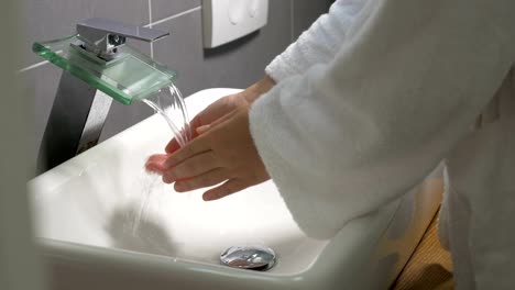 Woman-washing-hands-with-liquid-soap