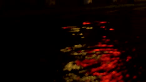 Close-up-view-of-river-wave-on-moving-boat-at-night,-Amsterdam,-Netherlands