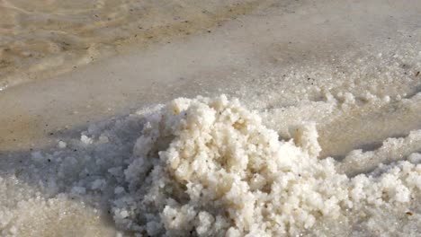 Woman-hands-taking-salt-from-the-shore-of-Dead-Sea