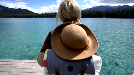 Young-woman-contemplating-nature-from-lake-pier,-Canada