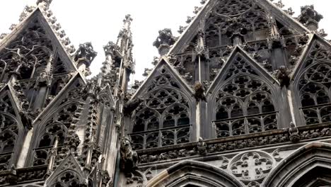 Closeup-of-Stephen-church,-Cathedral-tower-in-Vienna,-golden-cross-in-cloudy-day